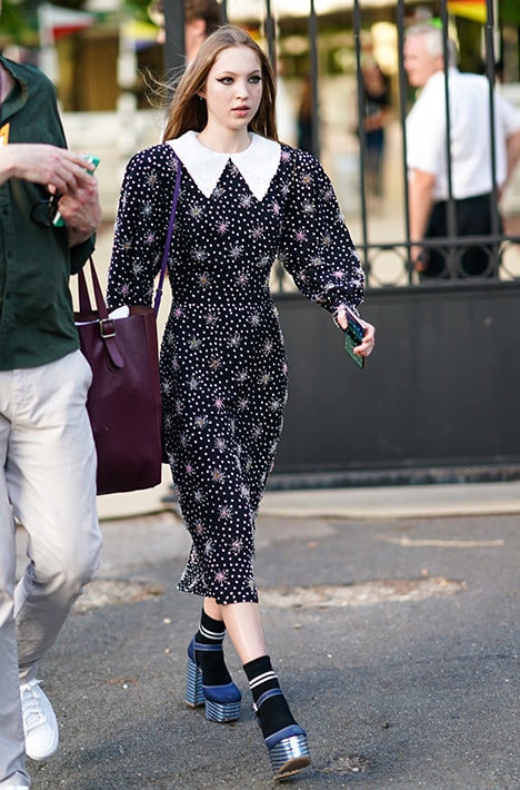 PARIS, FRANCE - JUNE 29: Lila Moss wears a dress with polka dots, printed features and a white collar, blue shoes, outside Miu Miu Club 2020, on June 29, 2019 in Paris, France. (Photo by Edward Berthelot/Getty Images)