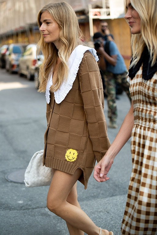 COPENHAGEN, DENMARK - AUGUST 10: Mie Juel outside Ganni wearing knitted brown dress with little yellow emoji smile on the bottom and white bag during Copenhagen fashion week SS21 on August 10, 2020 in Copenhagen, Denmark. (Photo by Raimonda Kulikauskiene/Getty Images)