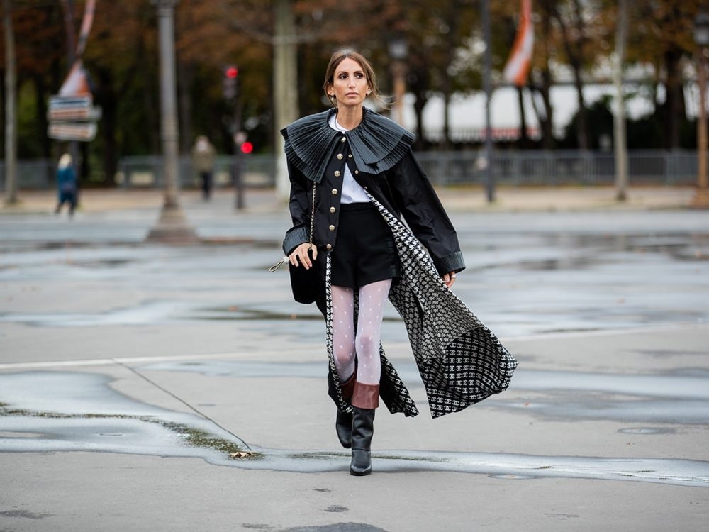 PARIS, FRANCE - OCTOBER 06: Chloe Harrouche seen wearing black coat, skirt, tights, black bag, boots outside Chanel during Paris Fashion Week - Womenswear Spring Summer 2021 : Day Nine on October 06, 2020 in Paris, France. (Photo by Christian Vierig/Getty Images)