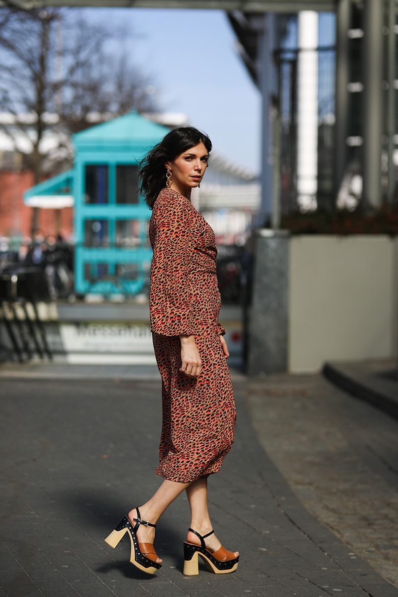 HAMBURG, GERMANY - MARCH 30: Anna Wolfers poses wearing camel and red leo midi wrap dress and wooden sole heels on March 30, 2021 in Hamburg, Germany. (Photo by Jeremy Moeller/Getty Images)