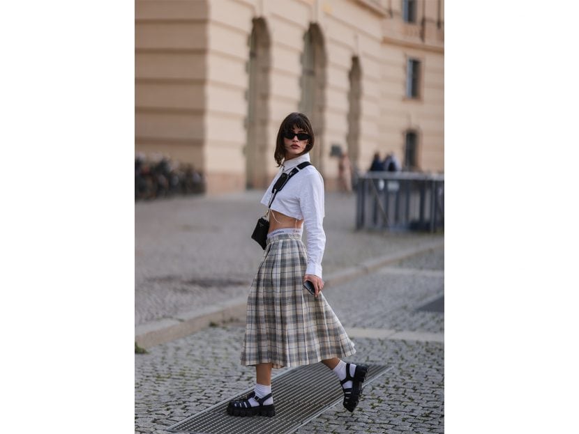 Lea Naumann wearing vintage midi skirt, Calvin Klein shorts, Tom Tailor cropped white flanell, Prada black sandals with with socks, Prada Triangle black bag, Chimi eyewear shades on May 31, 2022 in Berlin, Germany.