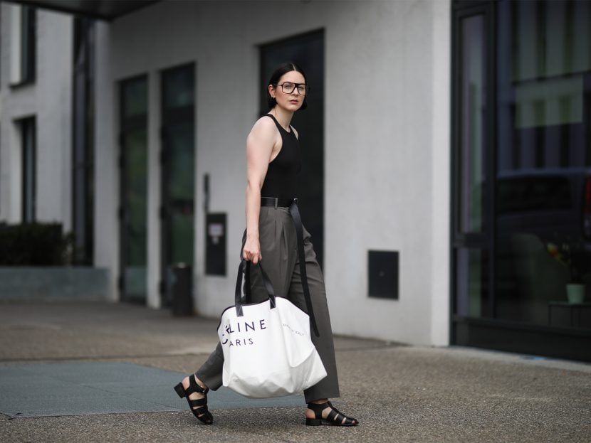 Maria Barteczko wearing Zara black body, Pixie Market grey pants, Asra black fisherman leather sandals, Celine oversized canvas tote bag and Victoria Beckham black oversized glasses on August 15, 2020 in Dusseldorf, Germany