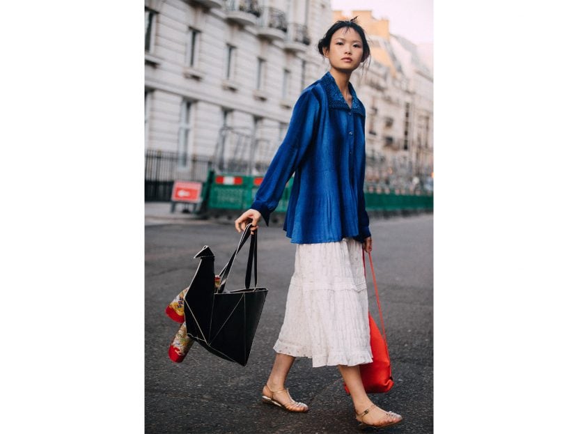 Lea Naumann wearing vintage midi skirt, Calvin Klein shorts, Tom Tailor cropped white flanell, Prada black sandals with with socks, Prada Triangle black bag, Chimi eyewear shades on May 31, 2022 in Berlin, Germany.